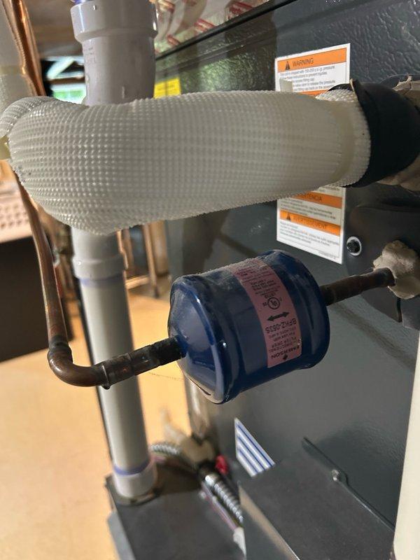 Performed air conditioning tune-up and diagnosed heat pump system with inadequate cooling performance. Initial temperature split measured at 11°F, indicating system inefficiency. Determined unit was overcharged with refrigerant after ruling out dirty filter and coil restrictions. Recovered excess refrigerant from system and restored proper charge levels. Verified normal operation with improved temperature split of 16°F, confirming resolution of cooling issue.
