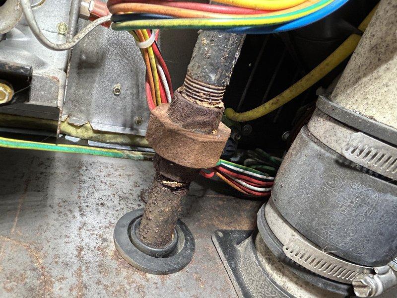 Responded to service call for inadequate cooling and weak airflow. Upon inspection, discovered a leaking evaporator drain pan causing water to cascade onto the secondary heat exchanger, blower assembly, and furnace components. Found extensive rust and corrosion on burners, gas valve, and ECM blower motor due to ongoing water intrusion. Secondary heat exchanger showed water saturation and debris accumulation, contributing to restricted airflow. The AC system (1990) and furnace (2013) both exhibited moisture damage throughout. Diagnosed that evaporator coil replacement is necessary to resolve the leak at its source. Recommended complete evaporator coil replacement along with cleaning of secondary heat exchanger and blower wheel to restore proper system operation and prevent further water damage to furnace components.