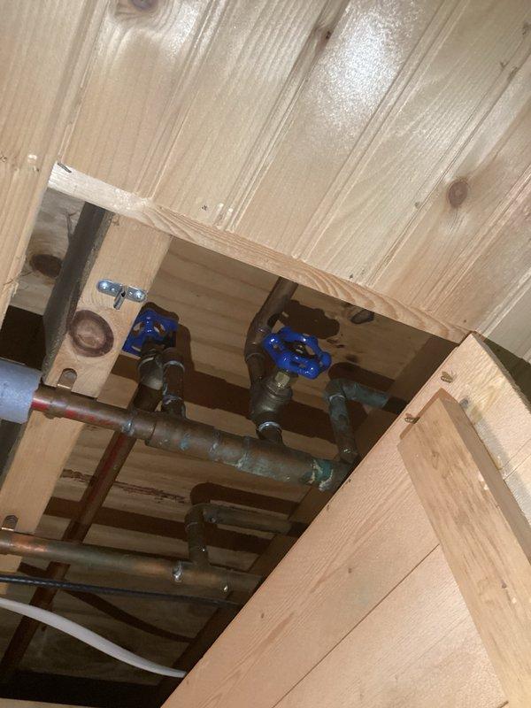 Conducted site assessment to provide estimate for repiping outdoor hose bibs to bypass water softener system, allowing untreated hard water supply for exterior irrigation. Inspected existing plumbing configuration through ceiling access panel, identifying current hose bib connections running through soft water lines. Evaluated feasibility of eliminating existing hose bib connections, adapting current lines to PEX, and routing new supply lines through mechanical room to tie in upstream of water treatment system. Assessed coordination opportunity with planned bathroom shower demolition due to existing leak damage, which would provide optimal access for running new water lines through ceiling cavity with minimal additional penetrations. Documented existing copper and galvanized steel piping configuration with shutoff valves, pipe routing through floor joists, and access points for proposed work. Provided comprehensive estimate options for either adding new dedicated water line to hose bib