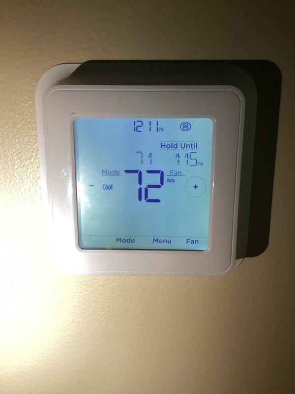 Responded to follow-up service call for attic air handler with intermittent thermostat "wait" status that had recurred after previous repair attempt. Upon arrival, verified thermostat was maintaining setpoint at 72°F with no "wait" error present and unit operating normally in cooling mode. Advised that thermostat replacement remains an option if issue continues to recur. During inspection of attic unit, discovered visible moisture accumulation on supply trunk ductwork. Investigation revealed kinked flexible supply duct restricting airflow to affected zone. Corrected duct kink to restore proper airflow, as restricted airflow combined with extreme ambient temperatures was causing condensation on duct surfaces. Confirmed air handler cooling performance adequate with no mechanical deficiencies noted at time of service.