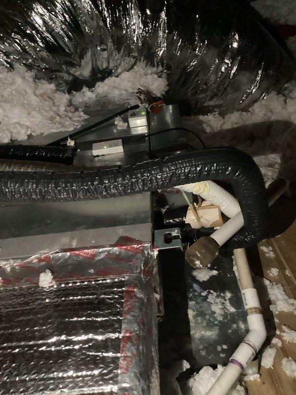 Responded to follow-up service call for attic air handler with intermittent thermostat "wait" status that had recurred after previous repair attempt. Upon arrival, verified thermostat was maintaining setpoint at 72°F with no "wait" error present and unit operating normally in cooling mode. Advised that thermostat replacement remains an option if issue continues to recur. During inspection of attic unit, discovered visible moisture accumulation on supply trunk ductwork. Investigation revealed kinked flexible supply duct restricting airflow to affected zone. Corrected duct kink to restore proper airflow, as restricted airflow combined with extreme ambient temperatures was causing condensation on duct surfaces. Confirmed air handler cooling performance adequate with no mechanical deficiencies noted at time of service.