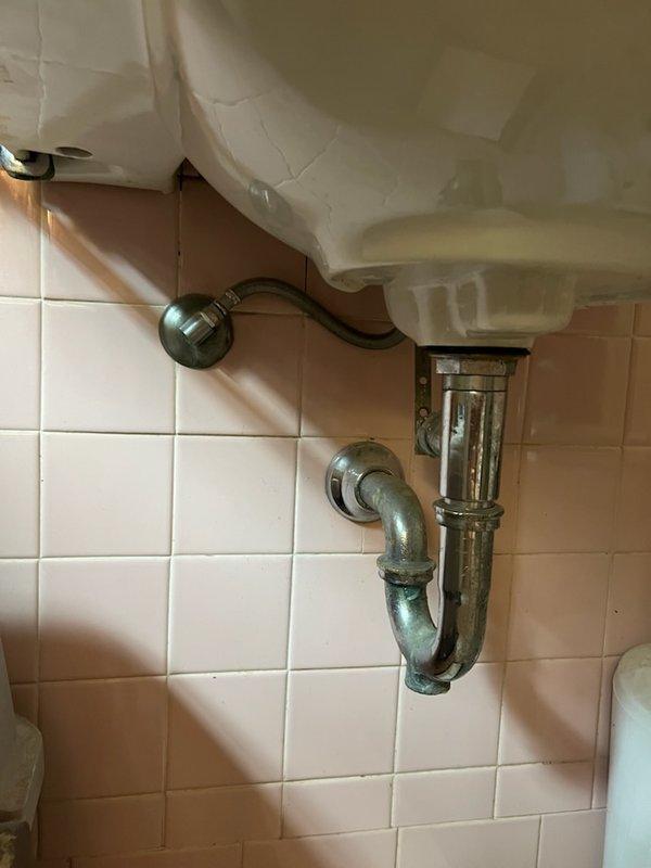 Responded to a completely clogged bathroom sink drain in an older home with a history of slow drainage and suspected cast iron pipe corrosion. Removed the existing P-trap assembly, which sustained damage during removal and required replacement. Cabled the drain line to its full accessible length using a drain snake to clear the blockage within the branch line. Successfully opened the drain and restored proper flow, though no debris was retrieved on the cable. Installed a new P-trap assembly and tested the system for proper drainage and leak-free operation, confirming full functionality upon completion.