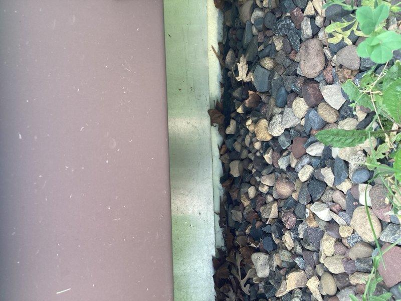 Provided estimate for new outdoor hose bib installation near AC unit. Scope includes upgrading existing water line to 3/4" supply, routing through attic space, and penetrating exterior wall adjacent to condenser location. Installation will include dedicated shut-off valve in mechanical room above water main and boiler drain for seasonal winterization to prevent freeze damage. Exterior hose bib will be mounted to post similar to existing AC disconnect switch configuration. Documented site conditions and existing infrastructure with photographs for accurate material specifications and labor requirements.