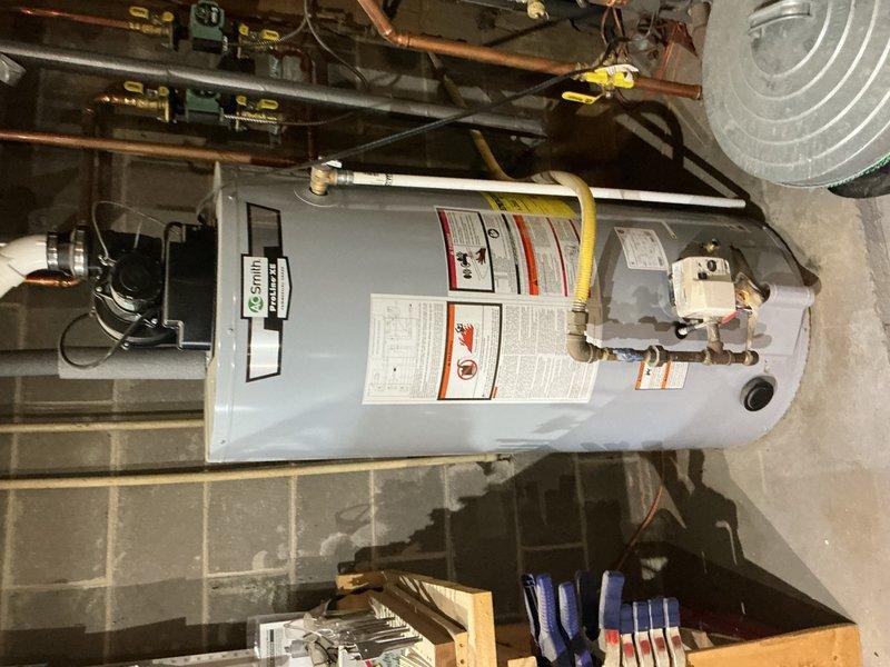 Performed annual inspection on A.O. Smith tanked water heater in preparation for property sale. Conducted comprehensive visual inspection of unit, verifying proper condition of temperature/pressure relief valve, discharge piping, gas line connections, and all copper supply lines. Briefly opened drain valve with attached hose to check for sediment buildup; found no sediment present, indicating proper maintenance history. Inspected all safety labels, electrical connections, and surrounding mechanical systems. Unit found to be in excellent operating condition with no deficiencies noted.