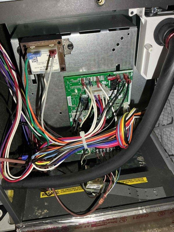 Responded to no cooling complaint on Mitsubishi 3.5-ton Intelliheat heat pump system with air handler and mini-split head. System was running continuously but unable to reach setpoint temperature at thermostat, while mini-split head connected to same outdoor condenser operated normally. Diagnosed communication fault between air handler control board and thermostat preventing proper system operation. Performed power cycle reset procedure on both furnace control board and Honeywell ProSeries thermostat to restore communication protocol. Verified thermostat display showed proper cooling mode and setpoint, confirmed system response to temperature adjustments, and restored normal cooling operation to air handler zone.