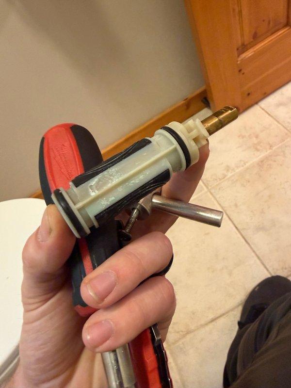 Responded to Jack and Jill bathroom shower with malfunctioning temperature control. Diagnosed faulty Moen shower cartridge preventing proper water temperature regulation. Removed existing cartridge using specialized extraction tool and replaced with new OEM cartridge, ensuring proper O-ring seals and correct installation depth. Tested operation to verify full temperature control functionality and checked for leaks at all connection points.