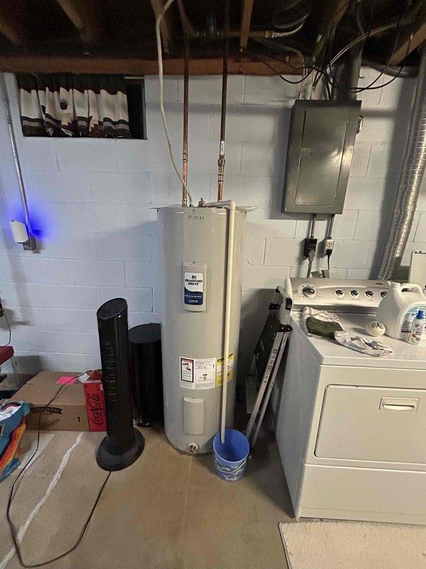 Performed annual AC tune-up on ML 17 system with reported reduced cooling performance and water leakage at furnace. Found system severely low on refrigerant charge with finger-tight service port caps and leaking Schrader core on suction side service valve. Recharged system to proper levels, tightened Schrader core using core removal tool which stopped the leak, secured all service port caps and nuts, and added UV dye as precautionary measure for future leak detection. Verified proper system operation with 20° temperature split across evaporator coil.
