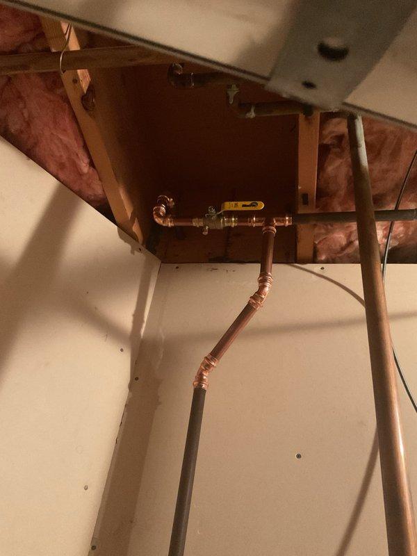 Replaced a failing water control valve up to 1" on the copper plumbing assembly located in the ceiling access area. The new ball valve with yellow handle was installed to restore proper flow control through the water line. Installation included proper fitting connections to the existing copper piping system, ensuring secure joints and leak-free operation for reliable water shut-off capability.
