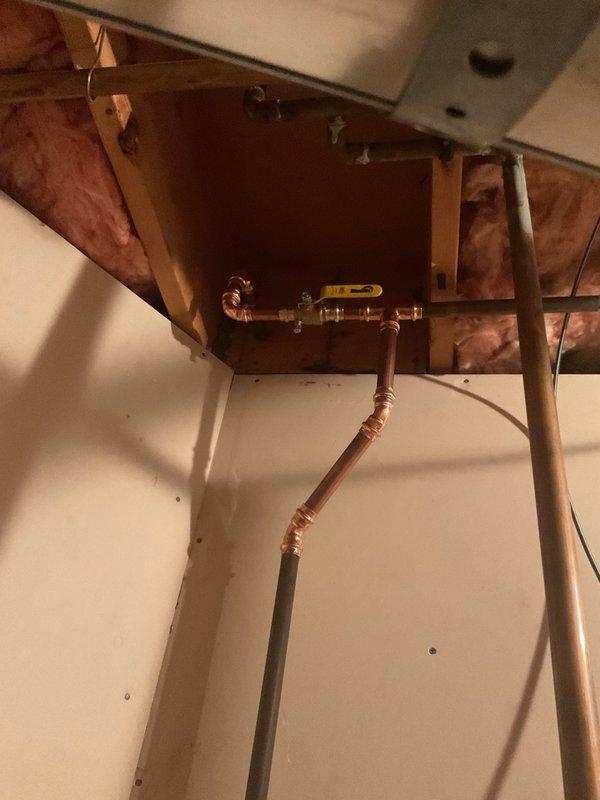 Replaced a failing water control valve up to 1" on the copper plumbing assembly located in the ceiling access area. The new ball valve with yellow handle was installed to restore proper flow control through the water line. Installation included proper fitting connections to the existing copper piping system, ensuring secure joints and leak-free operation for reliable water shut-off capability.