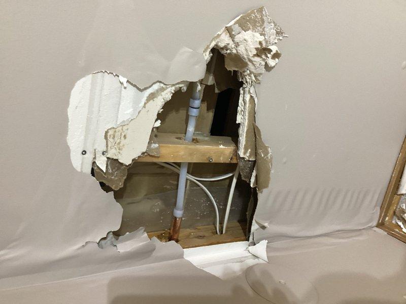 Responded to emergency call for frozen and failed exterior hose bibb that ruptured, causing water to spray inside the residence and resulting in approximately two inches of interior flooding. Coordinated with mitigation team on-site to access the affected area. Cut access hole in interior drywall to reach the damaged freeze-proof sillcock behind the wall cavity. Removed and replaced the failed hose bibb assembly, ensuring proper installation and secure mounting to exterior siding. Verified all connections were watertight and system was functioning properly upon completion.