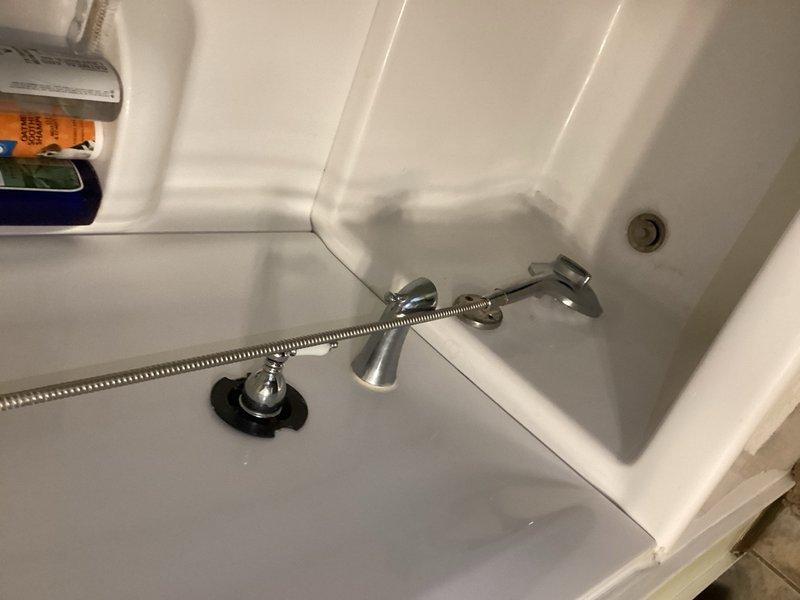 Completed comprehensive plumbing inspection as part of membership service. Inspected accessible plumbing fixtures including bathroom shower assembly with handheld unit and chrome fixtures, under-sink cabinet area with PVC P-trap drain configuration and shut-off valves. Documented water heater age and identified minor maintenance items, provided homeowner with findings and recommendations for noted concerns.