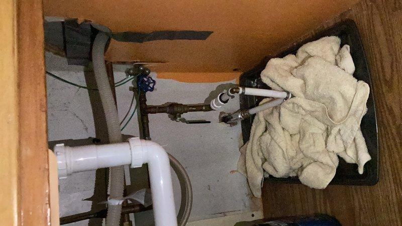 Completed comprehensive plumbing inspection as part of membership service. Inspected accessible plumbing fixtures including bathroom shower assembly with handheld unit and chrome fixtures, under-sink cabinet area with PVC P-trap drain configuration and shut-off valves. Documented water heater age and identified minor maintenance items, provided homeowner with findings and recommendations for noted concerns.