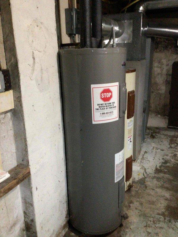 Performed furnace tune-up on a 1970s Janitrol unit at vacant property. Upon inspection, discovered cracked blower belt, rust-covered blower wheel fins, and excessive play in the blower motor shaft. Heat exchanger showed significant wear but no visible cracks or holes detected. Customer approved replacement of blower wheel and belt only at this time.