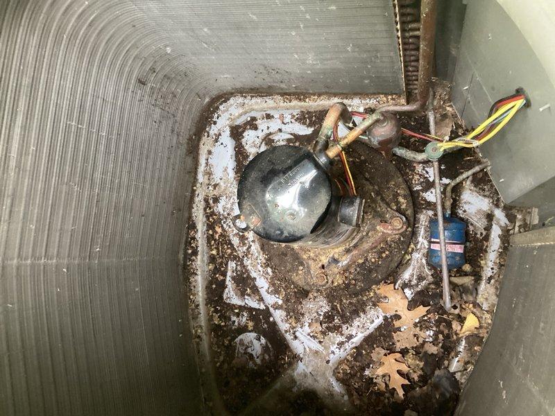 Responded to service call for non-operational system and discovered rodent damage to high limit pressure switch on the liquid line of the condenser. Removed compressor cover and found active rodent nest inside unit, which was extracted and disposed of. Thoroughly cleaned condenser coil and surrounding areas of debris and contamination. Replaced damaged high limit pressure switch with new component and completed all electrical connections and wiring. Cycled system to verify proper operation and added 1 lb of R-410A refrigerant to restore proper charge levels. Conducted final operational testing including pressure readings and temperature differentials. System restored to normal operating parameters with all safety controls functioning correctly.