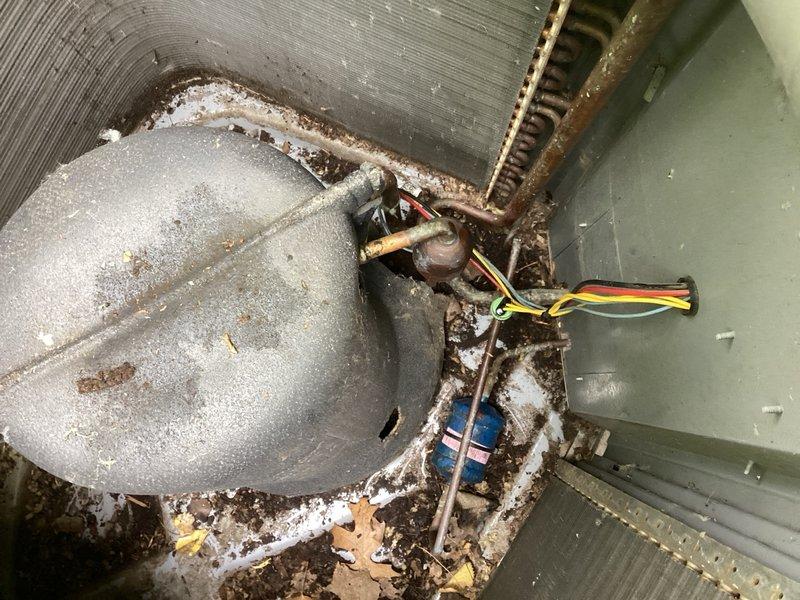 Responded to service call for non-operational system and discovered rodent damage to high limit pressure switch on the liquid line of the condenser. Removed compressor cover and found active rodent nest inside unit, which was extracted and disposed of. Thoroughly cleaned condenser coil and surrounding areas of debris and contamination. Replaced damaged high limit pressure switch with new component and completed all electrical connections and wiring. Cycled system to verify proper operation and added 1 lb of R-410A refrigerant to restore proper charge levels. Conducted final operational testing including pressure readings and temperature differentials. System restored to normal operating parameters with all safety controls functioning correctly.