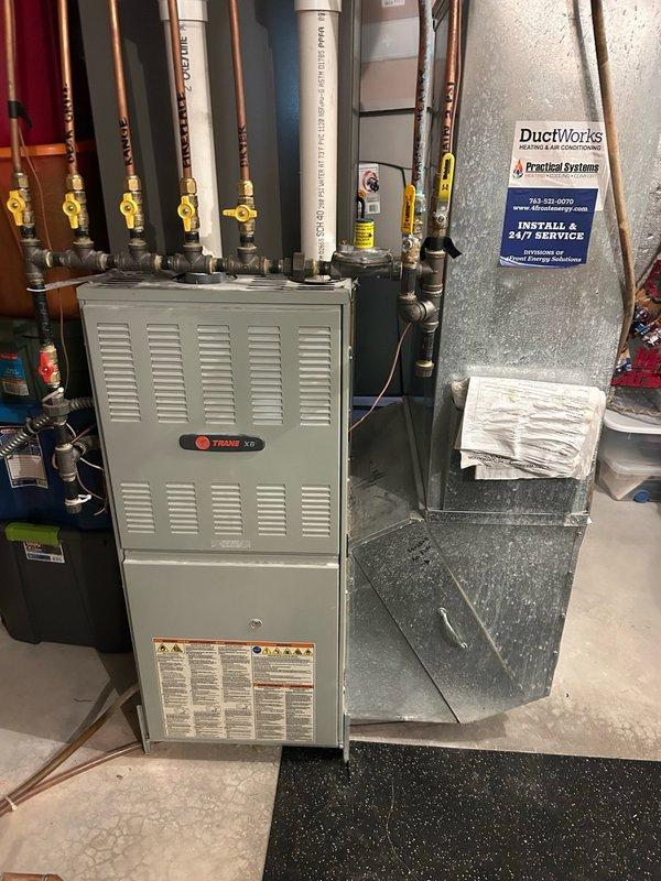 Completed comprehensive AC tune-up on residential Trane XE system. Upon inspection, found evaporator and condenser coils heavily impacted with multiple layers of dirt and debris, significantly restricting airflow and reducing system efficiency. Air filter was extremely dirty and improperly installed with incorrect airflow direction. Performed thorough cleaning of both coil assemblies to restore optimal heat transfer capability. Verified system refrigerant charge and operation within manufacturer specifications. Confirmed unit is cooling properly following service. Corrected air filter installation orientation and recommended establishing a six-month filter replacement schedule to prevent future airflow restrictions and maintain system performance.