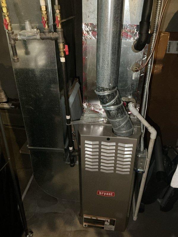 Responded to no cooling complaint on 10+ year old Goodman air conditioning system. Upon arrival, confirmed unit was not producing cool air and indoor temperature was rising. Performed diagnostic inspection of both outdoor condenser unit and indoor Bryant furnace/air handler system. No ice formation or condensation observed on refrigerant lines during initial visual inspection. Connected testing equipment to outdoor condenser unit to check system pressures and refrigerant charge. Diagnostic testing revealed system was completely empty of refrigerant, indicating a significant leak within the refrigerant circuit. Due to age of equipment and severity of refrigerant loss, recommended full system replacement rather than repair. Scheduled estimate appointment for new AC system installation. Documented equipment conditions with photos of outdoor condenser unit and indoor air handler for replacement planning purposes.