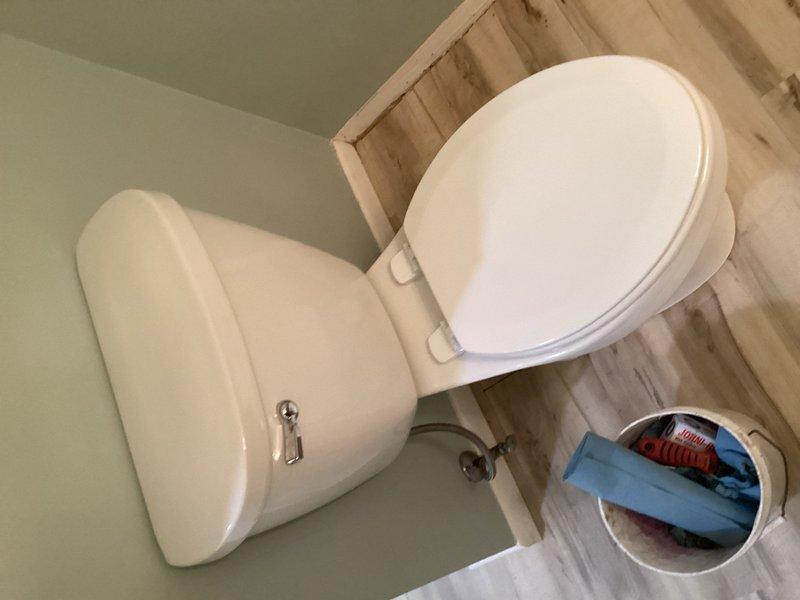 Responded to follow-up service call for toilet installation that was left for homeowner to complete after previous pipe repair work. Upon arrival, discovered approximately one foot of debris in the drainage pipe, a broken toilet flange requiring repair, and an improperly sealed 4-inch cleanout plug that was actively leaking water onto the floor. Cleared debris from pipe, repaired the damaged flange, properly set and secured the toilet to the repaired flange, and sealed the 4-inch cleanout plug to eliminate the water leak.