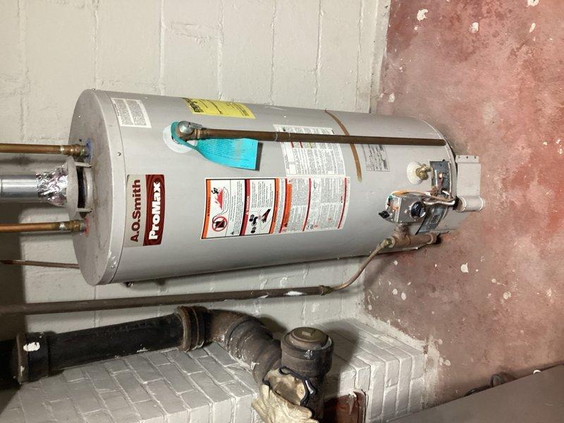 Responded to no hot water complaint on 18-year-old A.O. Smith ProMax tanked water heater. Diagnosed pilot light failure to remain lit and determined faulty gas valve (model 186300-000 37c73u-652). Due to age and condition of unit, recommended and installed replacement 40-gallon natural gas water heater with natural draft venting. Installation included 3-inch vent piping, three-quarter inch gas valve with three-quarter to half-inch reducer, and 4 feet of gas pipe. Verified all connections, tested for proper operation and gas leaks, and confirmed hot water delivery upon completion.
