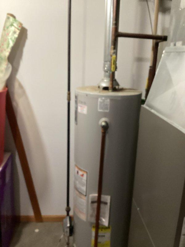 Responded to no hot water complaint on 18-year-old A.O. Smith ProMax tanked water heater. Diagnosed pilot light failure to remain lit and determined faulty gas valve (model 186300-000 37c73u-652). Due to age and condition of unit, recommended and installed replacement 40-gallon natural gas water heater with natural draft venting. Installation included 3-inch vent piping, three-quarter inch gas valve with three-quarter to half-inch reducer, and 4 feet of gas pipe. Verified all connections, tested for proper operation and gas leaks, and confirmed hot water delivery upon completion.