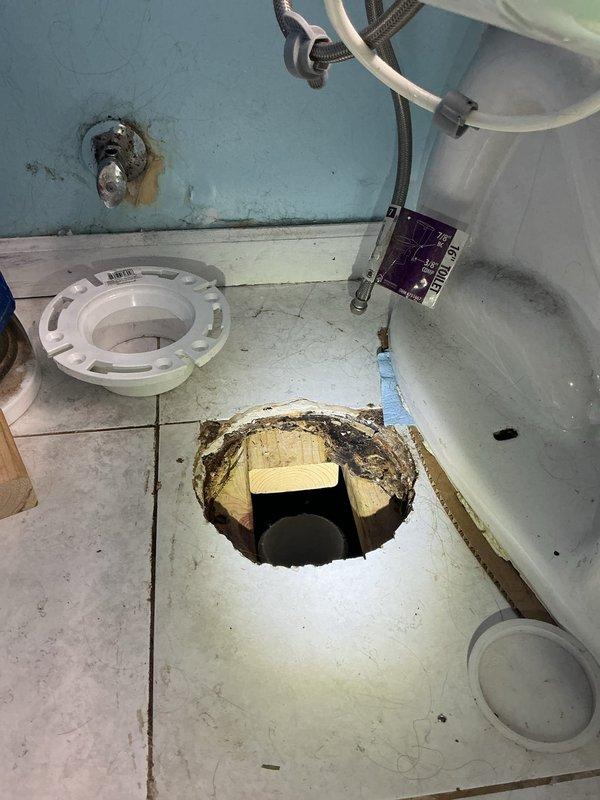 Returned to complete toilet installation after subfloor repair work. The existing floor surrounding the closet flange showed significant deterioration and structural damage, requiring complete reconstruction of the subfloor section beneath the flange location. Removed compromised flooring material and reinforced underlying support structures to ensure proper weight distribution and stability. Installed new closet flange with secure mounting to the rebuilt subfloor. Reset toilet onto the new flange assembly with proper wax ring seal and mounting hardware. Verified proper drainage function and secure installation upon completion.