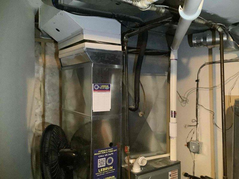 Completed phone follow-up to update existing estimate by adding furnace to previously quoted air conditioning system. Inspected and photographed basement mechanical area containing existing HVAC equipment and water heater to prepare comprehensive bid for furnace installation. Customer expressed enthusiasm about proceeding with both furnace and AC replacement and requested information on current promotional offers.