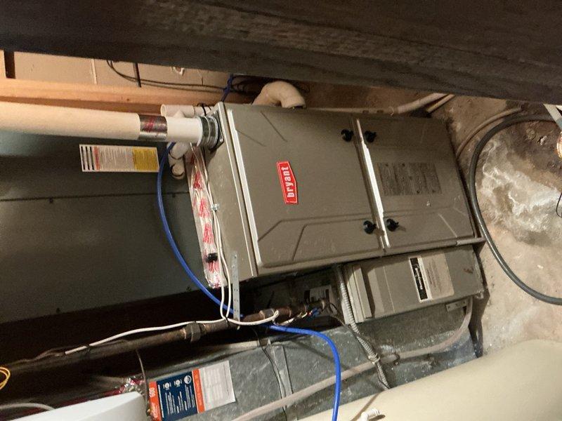 Responded to no cooling complaint on residential AC system. Upon arrival, found thermostat calling for cooling but blower motor not operating and no indicator lights on furnace. Voltage check confirmed no power to unit. Located tripped furnace switch at breaker panel in garage and reset. Verified blower motor operation and confirmed AC system functionality. Measured supply and return air temperatures with delta-t reading of 20 degrees, indicating proper system performance. Inspected outdoor condensing unit and found condenser coils heavily obstructed with cottonwood debris, restricting airflow. Advised homeowner of condition and recommended cleaning outdoor coil. Homeowner elected to perform coil cleaning themselves. Restored power and verified system operating properly before departure.