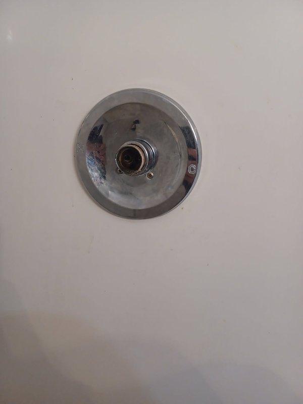 Responded to emergency water event in upstairs bathroom where shower faucet valve assembly failed and separated, causing water spray throughout the space. Upon arrival, water supply had been shut off by occupant to prevent further damage. Diagnosed failed shower cartridge with compromised internal components. Removed existing trim plate, extracted damaged cartridge internals, and installed new cartridge assembly. Tested valve operation for proper hot/cold water mixing and flow control. Reinstalled trim plate and verified complete repair with no leaks detected.