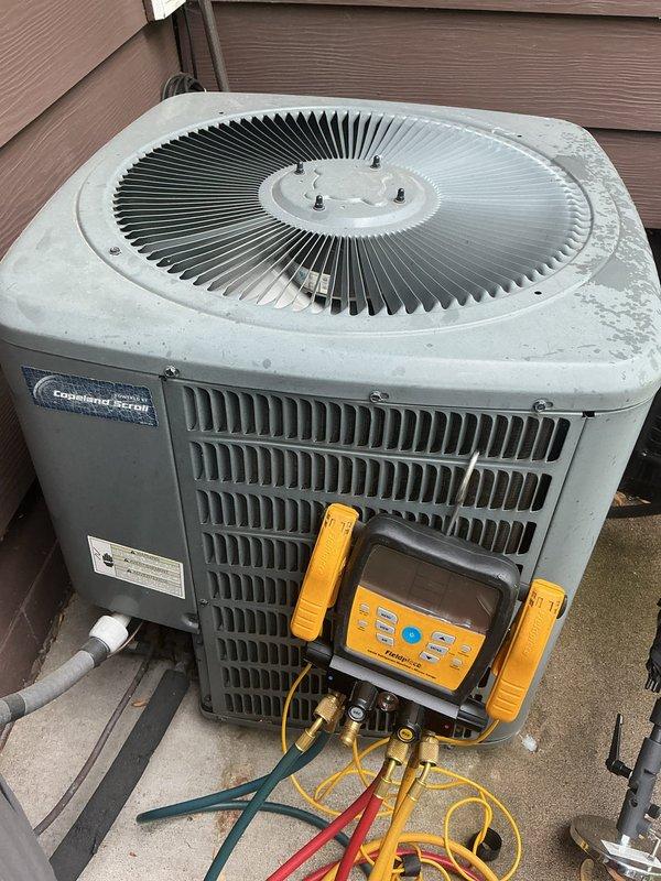 Responded to no cooling complaint on 10+ year old residential air conditioning system. Upon arrival, connected manifold gauges to condenser unit and confirmed system was operating with low refrigerant charge. Performed pressure diagnostics which indicated active refrigerant leak in system. Discussed repair options with customer including leak detection service with UV dye injection, leak repair, and system recharge versus full system replacement given age of equipment. Customer opted for system replacement. Provided estimate for new AC installation. System left in current condition pending replacement approval.