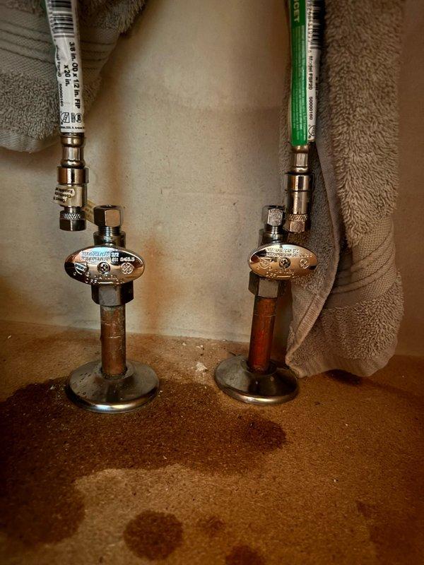 Responded to service call for leaking lavatory faucet and malfunctioning shut-off valves. Upon inspection, determined that both shut-off valves under the sink were leaking and failed to properly isolate water flow, creating potential emergency access issues. Removed existing deteriorated shut-off valves and supply lines from copper stub-outs. Installed new BrassCraft quarter-turn angle stop valves with oval handles on both hot and cold water lines. Connected new braided stainless steel flexible supply lines from the angle stops to the lavatory faucet connections. Verified all connections for proper seal and tested valve operation to ensure complete water shut-off capability. Checked for leaks under pressure and confirmed system integrity. Cleaned work area and removed all debris. All components now functioning properly with reliable water isolation capability restored.