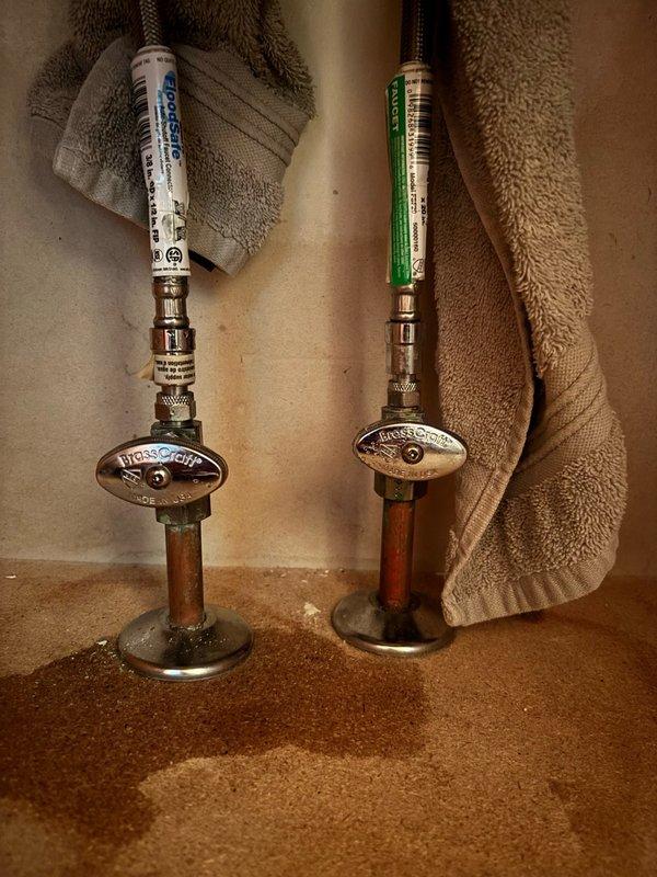 Responded to service call for leaking lavatory faucet and malfunctioning shut-off valves. Upon inspection, determined that both shut-off valves under the sink were leaking and failed to properly isolate water flow, creating potential emergency access issues. Removed existing deteriorated shut-off valves and supply lines from copper stub-outs. Installed new BrassCraft quarter-turn angle stop valves with oval handles on both hot and cold water lines. Connected new braided stainless steel flexible supply lines from the angle stops to the lavatory faucet connections. Verified all connections for proper seal and tested valve operation to ensure complete water shut-off capability. Checked for leaks under pressure and confirmed system integrity. Cleaned work area and removed all debris. All components now functioning properly with reliable water isolation capability restored.