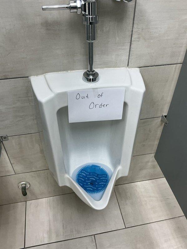Responded to service call for malfunctioning automatic flush toilets and severely clogged urinal. Diagnosed urinal blockage located past the trap requiring fixture removal. Removed wall-mounted urinal from mounting bracket and cabled drain line approximately 20 feet to clear obstruction. Confirmed drainage by running water through line with hose to verify no backup. Reinstalled urinal, tested flush valve operation, and verified proper drainage with no leaks. Provided quote for replacement of six automatic flush toilets with standard mechanical flush valves to eliminate ongoing battery maintenance issues.