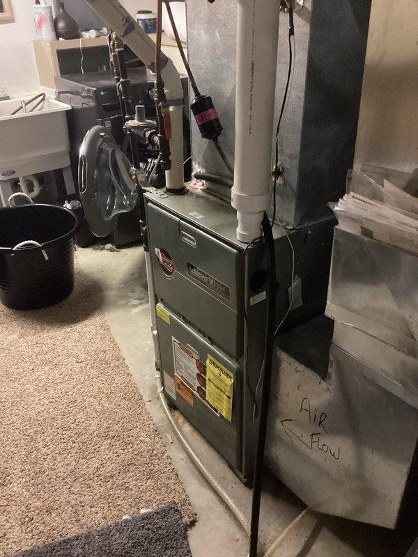 Responded to no cooling complaint on 4-year-old Lennox air conditioning system. Upon inspection, found outdoor condenser unit with excessive dirt and debris accumulation on coil fins restricting airflow. Cleaned condenser coil and exterior components to restore proper airflow. Performed refrigerant charge verification and discovered system operating with low refrigerant levels, indicating potential leak or improper initial charge. Advised property owner that low refrigerant on relatively new equipment should be covered under manufacturer or installation warranty and recommended contacting original installing contractor for warranty service and proper refrigerant leak diagnosis.