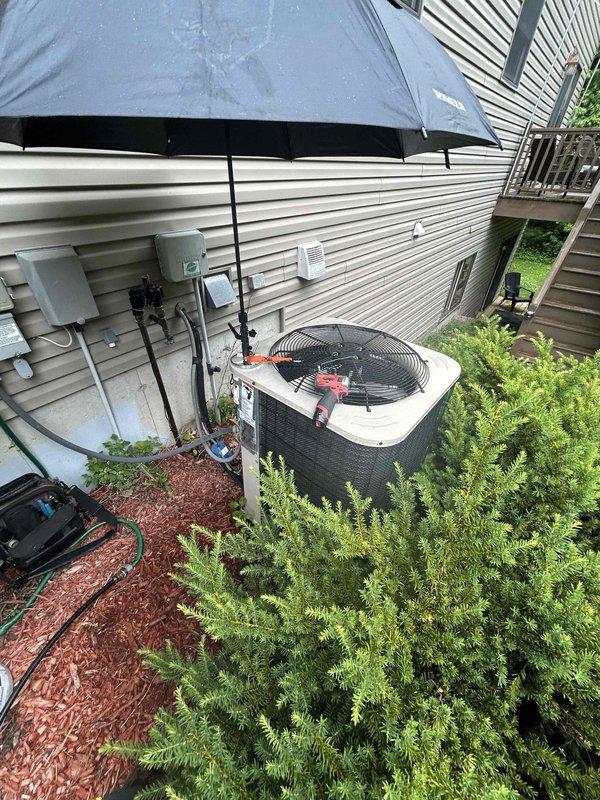 Responded to no cooling complaint on 10+ year old central air conditioning system with warm air from vents. Found outdoor unit failed to start due to high-pressure safety trip. Reset high-pressure switch by disconnecting wires from control board, allowing equipment to restart successfully. Monitored system operation for 25 minutes to verify proper function. Observed suction pressure reading slightly low but confirmed adequate cooling performance with 20-degree temperature split across evaporator coil. Evaporator coil showed proper refrigerant distribution with condensation forming along entire coil surface. Inspected outdoor condenser coil and confirmed clean condition with no obstructions or debris. Unable to identify specific cause of high-pressure trip as all components appeared to be functioning within normal parameters. Reset defrost board to restore system to factory settings. System operating properly at time of departure with no further issues detected.
