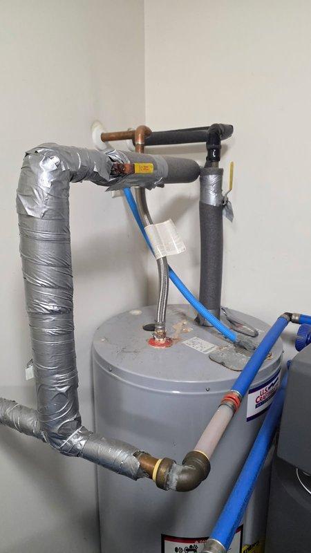 Responded to service call for non-functional electric water heater that had reached end of service life at 25 years old. Removed and properly disposed of existing 50-gallon electric water heater. Installed new 50-gallon electric water heater with proper electrical connections, copper supply lines, and pressure relief valve. Configured hot and cold water piping with appropriate shut-off valves and insulated all exposed pipes to prevent heat loss and condensation. Integrated new unit with existing water treatment system and pressure tank. Tested all connections for leaks, verified proper electrical operation, and confirmed adequate hot water delivery throughout the system.