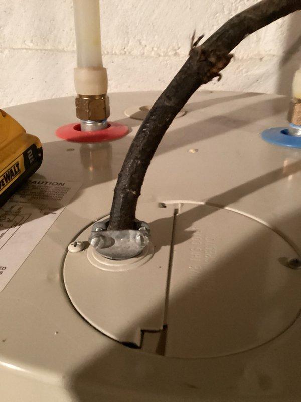 Responded to no hot water complaint and found 50-gallon electric water heater with burned-out heating elements and extensive age-related deterioration, including severely corroded piping connections. Inspected electrical panel and water heater condition, documented deteriorated components with photos. Recommended full unit replacement due to age and condition, provided estimate for new 50-gallon electric water heater installation with option for 40-gallon unit per customer preference, scheduled installation for following morning.