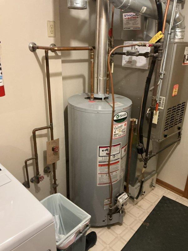 Responded to no hot water complaint on 10-year-old AO Smith tanked water heater. Upon diagnostic inspection, determined unit was not registering flame and unable to ignite burner assembly. After troubleshooting confirmed failure of ignition system components, replaced the water heater with new unit. Completed installation with proper copper piping connections, safety valves, and code-compliant configuration. Verified all connections secure, tested for proper operation, and confirmed hot water delivery restored to residence.
