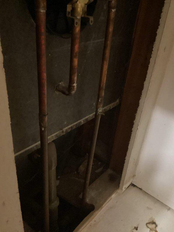 Responded to dripping shower faucet caused by faulty cartridge. Upon inspection, discovered no shut-off valves present at the shower valve assembly, requiring wall access to address the plumbing system. Opened wall cavity to expose copper supply lines and shower valve infrastructure. Installed new shut-off valves on hot and cold water supply lines to provide future serviceability. Replaced defective shower cartridge and associated internal components within the valve body. Tested all fixtures for proper operation and verified leak elimination. Restored wall access point upon completion of repairs.