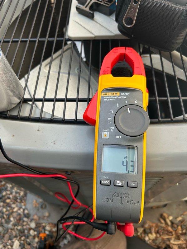 Responded to no cooling complaint following recent power surge and outage. Upon arrival, both AC systems were operational after breaker reset, but full diagnostic inspection was requested. Tested dual run capacitor on first unit (right side) and found complete failure, reading 0/4.3 MFD versus rated 40/5 MFD. Compressor was only able to start with assistance from existing hard start kit due to failed capacitor. Replaced failed dual run capacitor and verified normal system operation restored. Inspected second AC unit and found all major components functioning properly. Removed rodent nest from second unit. Verified refrigerant operation on both systems operating within normal parameters. Measured and confirmed supply and return air temperatures on both units within acceptable range. Noted humidifier solenoid stuck in open position requiring future service if correction desired. Both AC systems left operating normally with proper cooling restored.