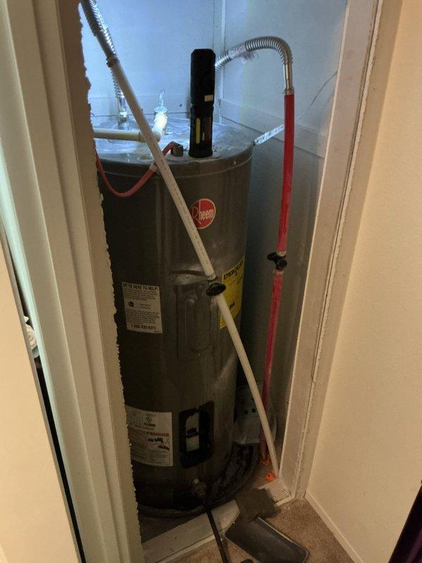 Responded to no hot water complaint on 6-year-old electric water heater. Upon inspection, discovered tank rupture requiring immediate replacement. Removed and properly disposed of failed unit. Installed new Bradford White 30-gallon electric water heater with 10-year warranty in utility closet location. Connected all water supply lines, installed temperature and pressure relief valve, and verified proper electrical connections. Tested unit operation and confirmed hot water delivery to fixtures throughout residence.