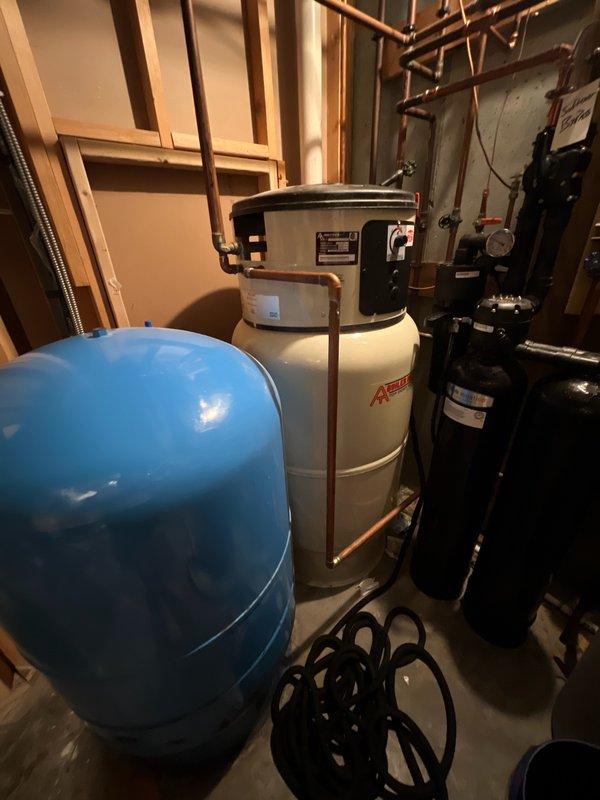 Responded to no hot water call at property with new homeowners unfamiliar with the heating system. Upon arrival, found boiler displaying ER4 error code indicating low water condition—the second occurrence within two months. Added water to the boiler system, which restored proper operation and unit fired successfully. Advised customer that if low water condition recurs, a pressure test of the radiant floor heating system will be necessary to identify potential slow leaks in the hydronic loop.