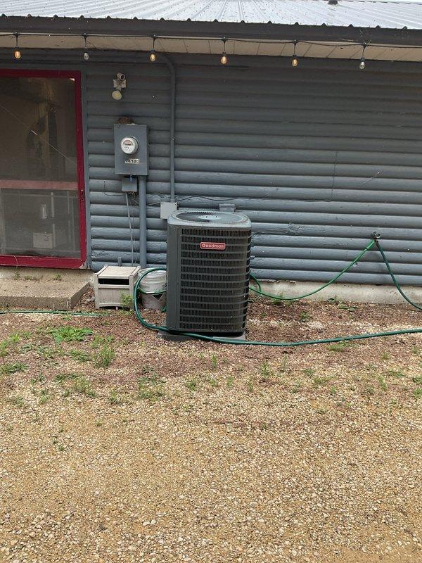 Responded to no air conditioning call on aging HVAC system. Diagnosed blower motor failure to start; performed jumper test confirming motor operational but control board not sending signal. Removed and inspected control board, discovering visible water damage and moisture infiltration. Unit installed at floor level by previous contractor, making it susceptible to water splash and repeated board failures. Provided pricing options for replacement control board and recommended advisor consultation to evaluate either raising furnace installation height or full system replacement due to chronic moisture-related issues and installation concerns.