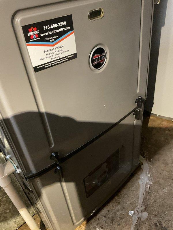 Responded to no air conditioning call on aging HVAC system. Diagnosed blower motor failure to start; performed jumper test confirming motor operational but control board not sending signal. Removed and inspected control board, discovering visible water damage and moisture infiltration. Unit installed at floor level by previous contractor, making it susceptible to water splash and repeated board failures. Provided pricing options for replacement control board and recommended advisor consultation to evaluate either raising furnace installation height or full system replacement due to chronic moisture-related issues and installation concerns.
