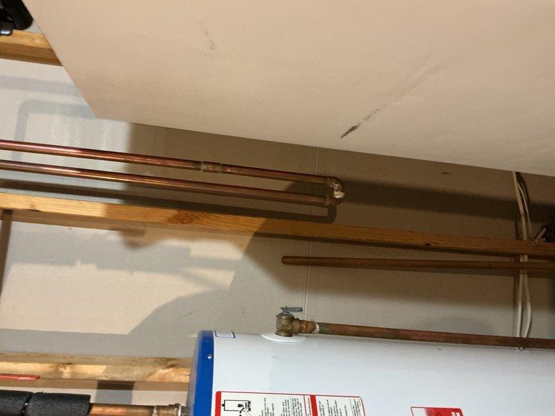Responded to a water leak caused by a damaged cast iron bathtub drain assembly that was compromised during an attempted self-repair. Cut access hole in basement ceiling below the tub to reach the drain piping, removed the failed drain assembly, and installed a complete replacement tub drain with proper sealing. Tested the system for leaks and verified proper drainage function upon completion.
