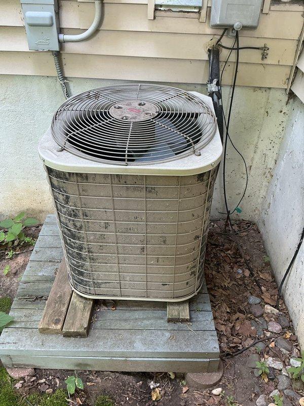 Responded to no cooling call on 24-year-old air conditioning system. Found failed fuses in outdoor disconnect, which were replaced to restore power to the condenser unit. Condenser fan motor required manual rotation to initiate operation, indicating failing motor bearings or capacitor issues. System returned to operational status as a temporary repair with no guarantee due to age and condition of equipment. Replaced dirty air filter during service. Scheduled system replacement estimate due to advanced age and deteriorating components that make further repairs inadvisable.