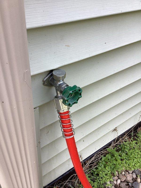 Responded to service call for leaking outdoor hose bibb and kitchen plumbing issues. Replaced faulty washer component on exterior spigot, resolving the leak at the hose bib connection point. Completed full replacement of kitchen faucet at double-basin undermount sink. Documented completed installations with photographs showing properly functioning exterior spigot with attached garden hose and updated kitchen faucet fixture.