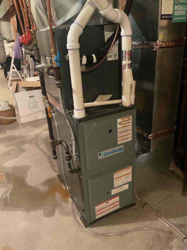 Responded to call for water leaking from Daikin furnace system that had been shut down by customer due to recurring water accumulation on floor. Diagnosed failed evaporator coil drain pan as source of leak. Removed and replaced defective drain pan, verified proper condensate drainage through white PVC drain lines, and confirmed all connections were secure with no further leakage detected upon system restart and testing.