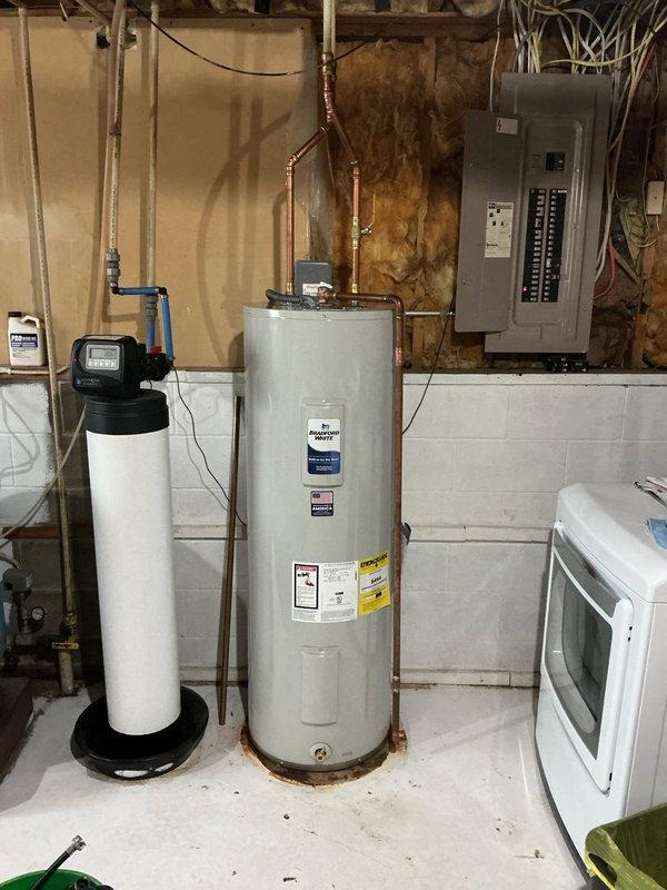 Responded to no hot water complaint with circuit breaker tripping immediately upon reset attempt. Upon inspection, discovered 10-year-old tanked water heater was leaking and causing electrical fault. Removed and replaced failed unit with new water heater, reconnected copper supply and discharge piping, verified all connections for proper seal, restored power, and tested system operation to confirm hot water delivery and no further electrical issues.