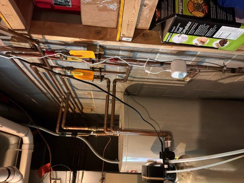 Conducted on-site evaluation for water heater replacement in residential basement. Assessed existing electric water heater installation, including current plumbing infrastructure with copper supply lines and connections. Evaluated utility room configuration and available space for potential upgrade options. Reviewed feasibility of converting from electric to either hybrid heat pump water heater or gas-fired unit, examining existing electrical service, venting requirements, and gas line accessibility. Documented current installation conditions and utility connections through photographic documentation to provide accurate replacement recommendations and material requirements for customer consideration.