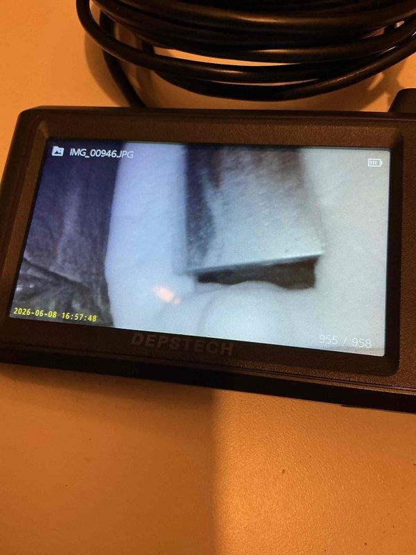 Responded to a no cooling call on a 22-year-old Nordyne air conditioning system. Upon arrival, found the unit running but discharging warm air. Conducted thorough system evaluation and discovered the evaporator A-coil completely frozen solid with ice accumulation. Further inspection revealed the refrigerant line set extending to the compressor was also frozen. System operates on R22 refrigerant, which is now obsolete and no longer manufactured. Used inspection camera to document internal coil condition and photographed affected components including frozen lines and valve assembly. Given the age of the equipment, extent of the freezing issue, and obsolete refrigerant type, recommended system replacement consultation. Coordinated scheduling for comfort advisor to provide replacement options and discuss modern, more efficient cooling solutions.